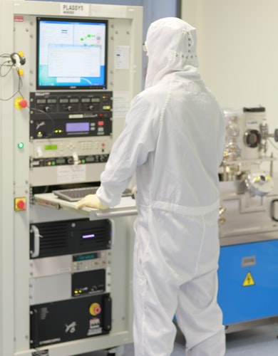 scientist in clean suit working in a cleanroom
